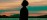 Backlit silhouette of practitioner arriving at their building