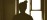 Practitioner silhouette at desk in softly lit interior