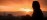 Woman standing arms outstretched on a hilltop at dawn - expansive sunrise sky for healing practitioners